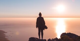 person standing on brown rock formation